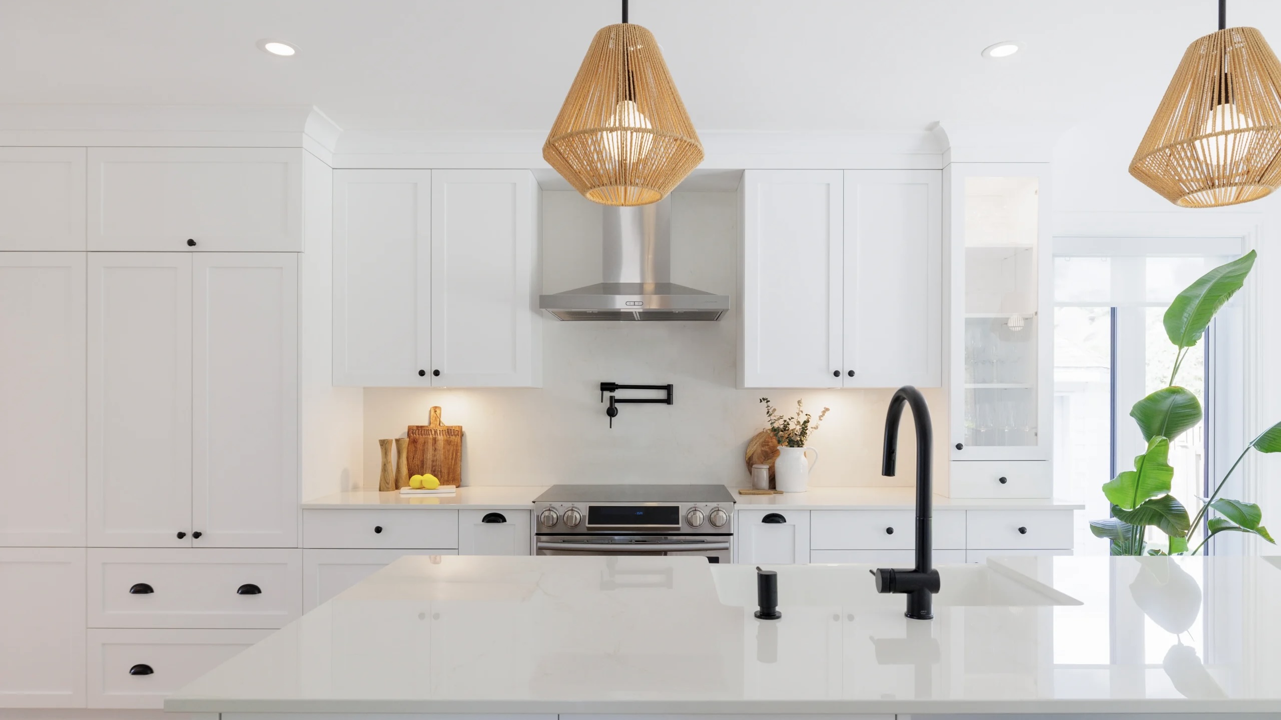 White kitchen renovation idea with character, woven pendant light and black accents.