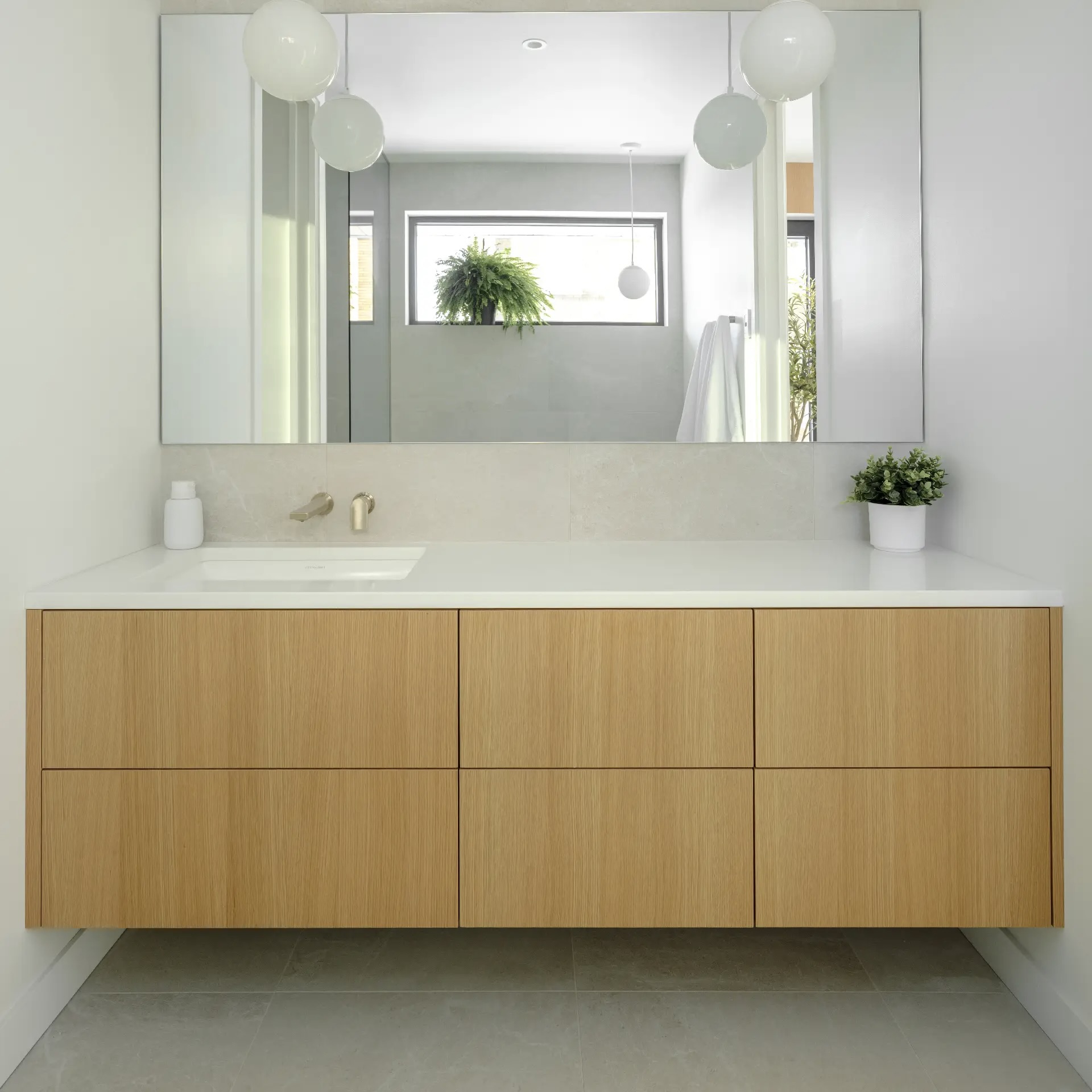 Contemporary powder room with light-wood vanity and mirror, representing a trendy, clean style suited to small spaces.