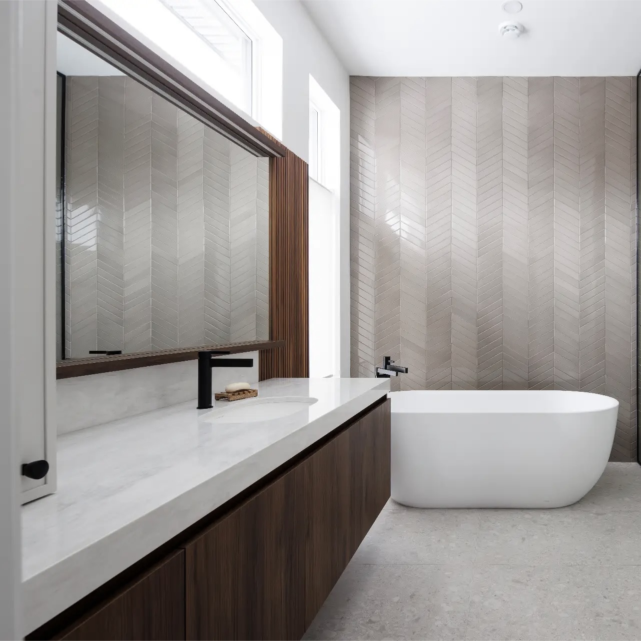 View of a bathroom with a mirror and these standards